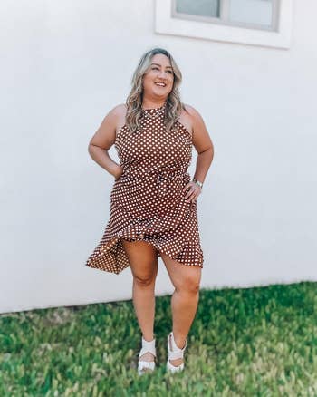 reviewer wearing brownish  dress