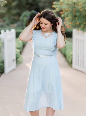 reviewer wearing the light blue dress