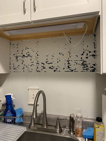 residue left behind from reviewer removing adhesive backsplash