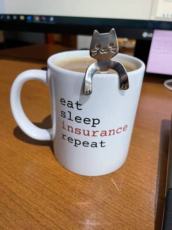 a cat spoon in a coffee mug