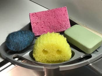 a sponge daddy and several other sponges on the kitchen caddy