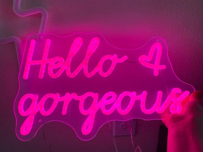 A pink neon sign that says 