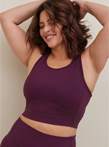 model wearing a dark purple longline sports bra