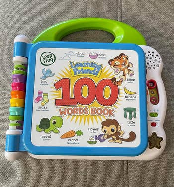 LeapFrog Learning Friends 100 Words Book featuring animal illustrations and various words in English and Spanish for language learning