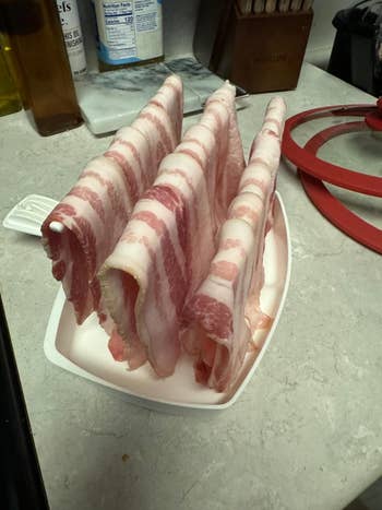 Raw bacon slices draped upright successful  a foam tray connected  a room  counter