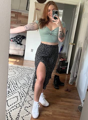 a reviewer wearing the skirt in black with a white dotted print