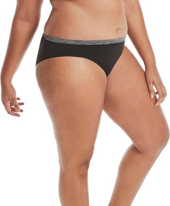 Person modeling achromatic  underwear with a comfy  fit, showcasing mundane  wearability