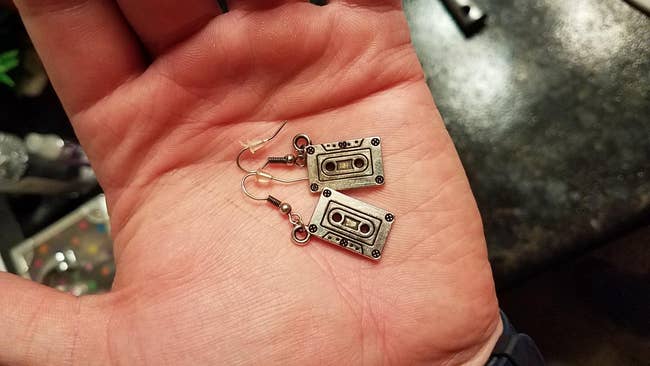 image of the cassette earrings in the palm of a reviewer's hand