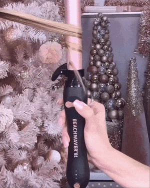 a gif of the rotating beachwaver curling iron in use