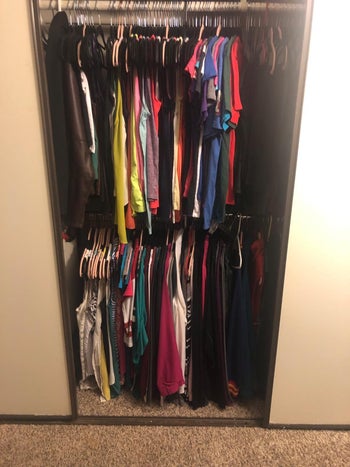 the same closet with clothes hanging from both the top and double rod