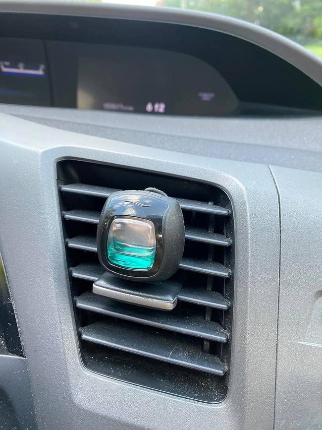 reviewer with car vent clip on their vent