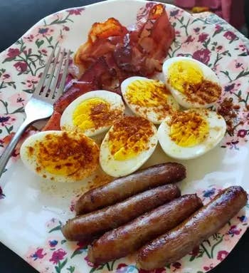 plate with hard boiled eggs, bacon, and sausage 