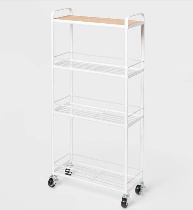 White and wooden narrow cart with wheels on a white background