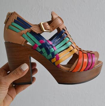 reviewer holding the multicolored platform sandal