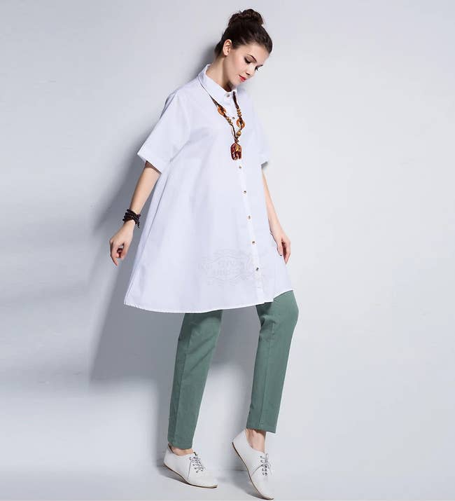model wearing the white button down with green pants and white shoes
