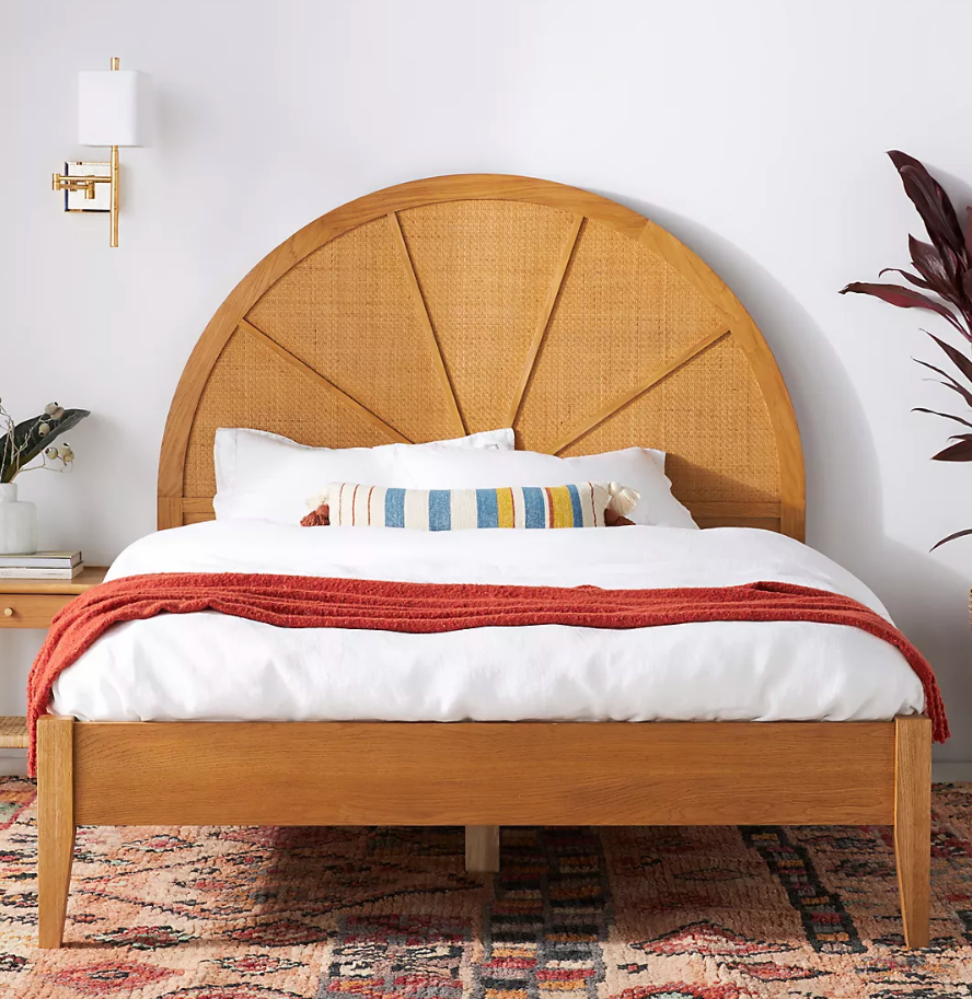 wooden bed frame with rounded cane headboard