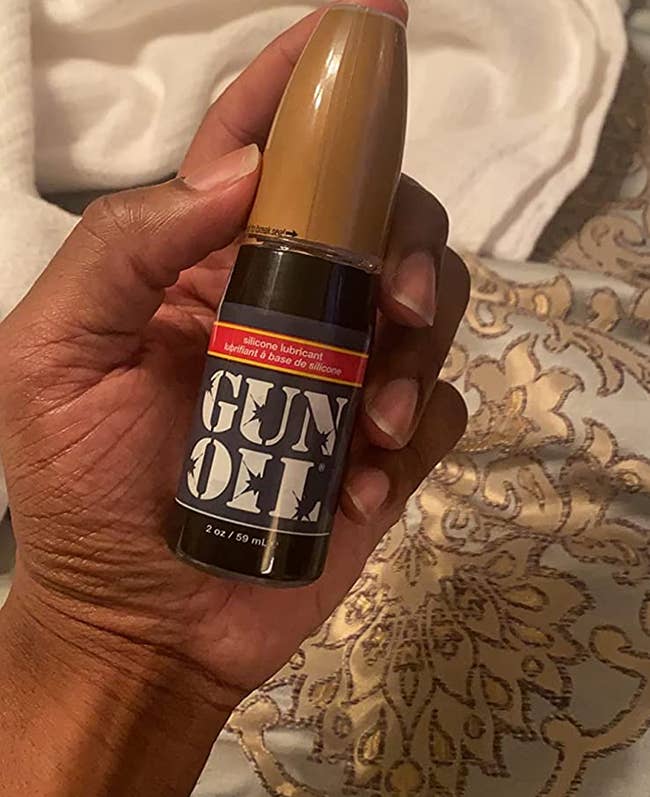 Reviewer holding bottle of Gun Oil lubricant