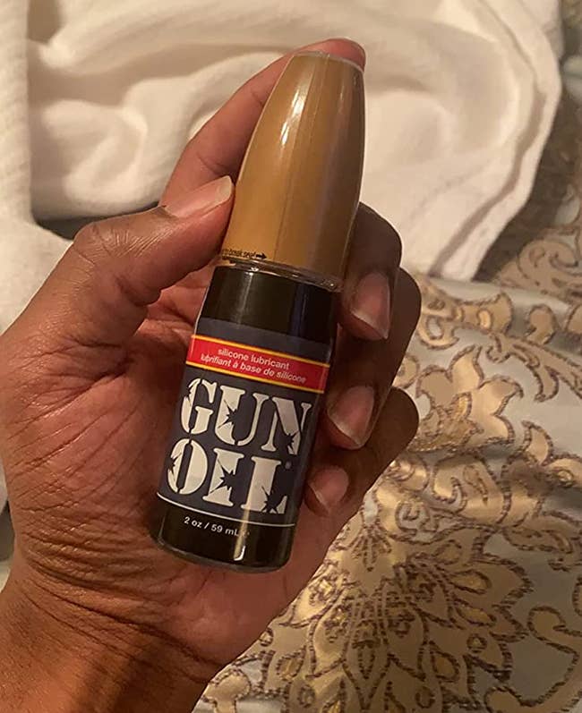 Reviewer holding bottle of Gun Oil lubricant
