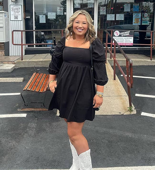 reviewer in black dress and white cowboy boots
