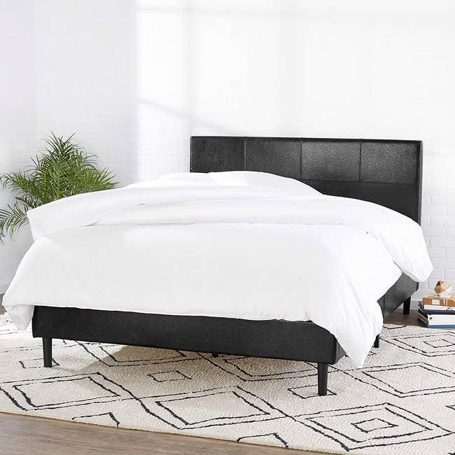 the black upholstered bed 