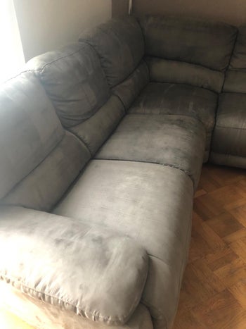 reviewer after image of the identical sofa with the darkish stains long past
