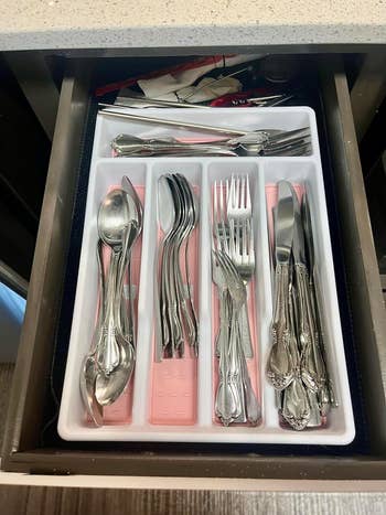 a reviewer's silverware organizer with pink lining