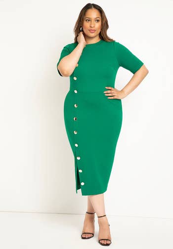 model wearing green midi dress with button detail down the side and a leg slit