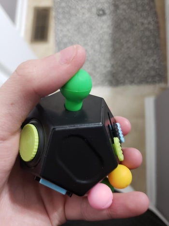 Another reviewer holding the fidget toy