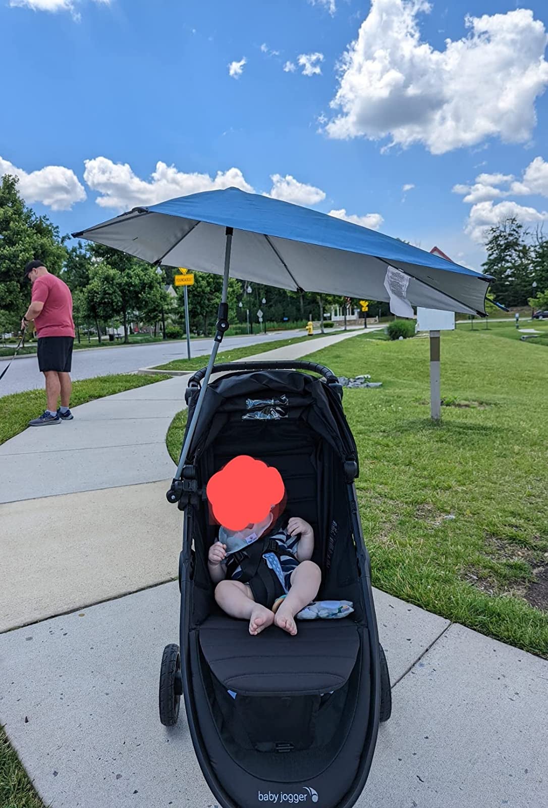 reviewer's photo of a blue umbrella attached to a stroller