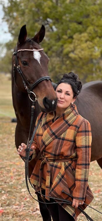 a reviewer wearing the coat in a caramel color