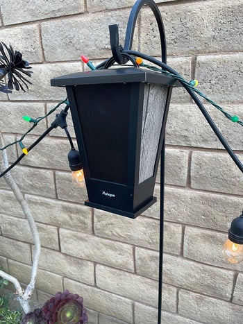 a speaker hung on a shepherd's hook