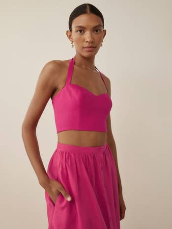 another model wearing the fuchsia pink crop top and skirt