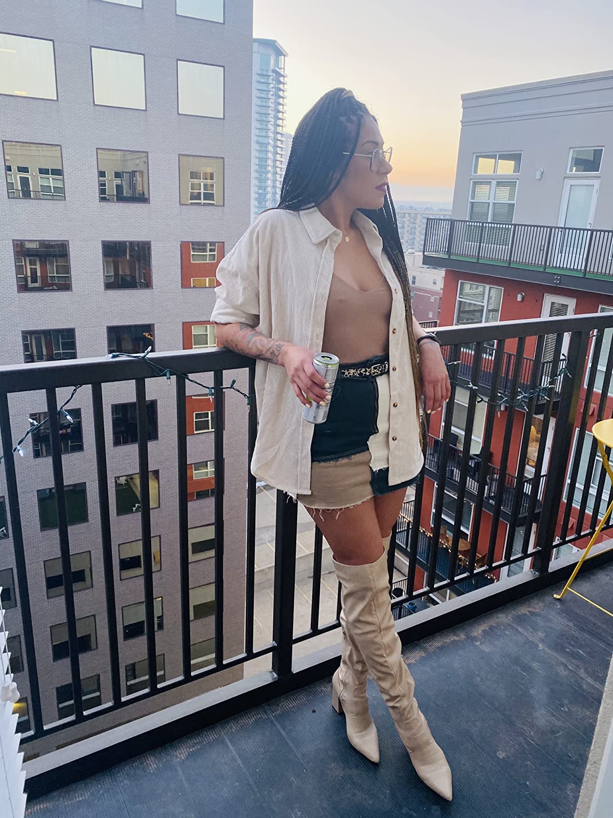 Reviewer is wearing the white shacket with a nude top and a multi-colored skirt