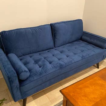 reviewer photo of navy blue velvet sofa