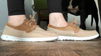 reviewer wearing the boat shoes in the tan color