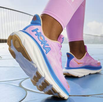 model wearing the pink and blue sneakers