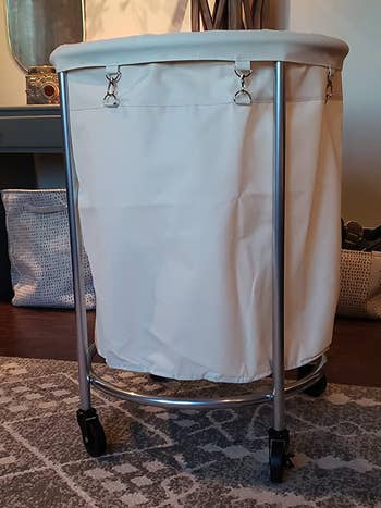 Reviewer image of white laundry basket with wheels