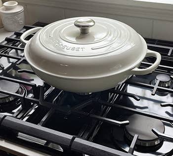 reviewer photo of the white braiser on a stovetop