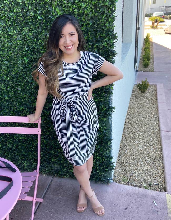 reviewer wearing the black striped midi dress