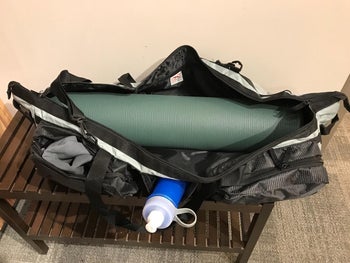 reviewer green yoga mat in a yoga mat bag