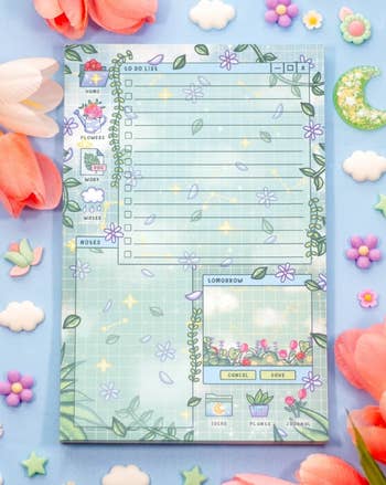 Cute, garden-themed to-do database and planner leafage decorated with flowers and stars, surrounded by artificial tulips and star-shaped embellishments