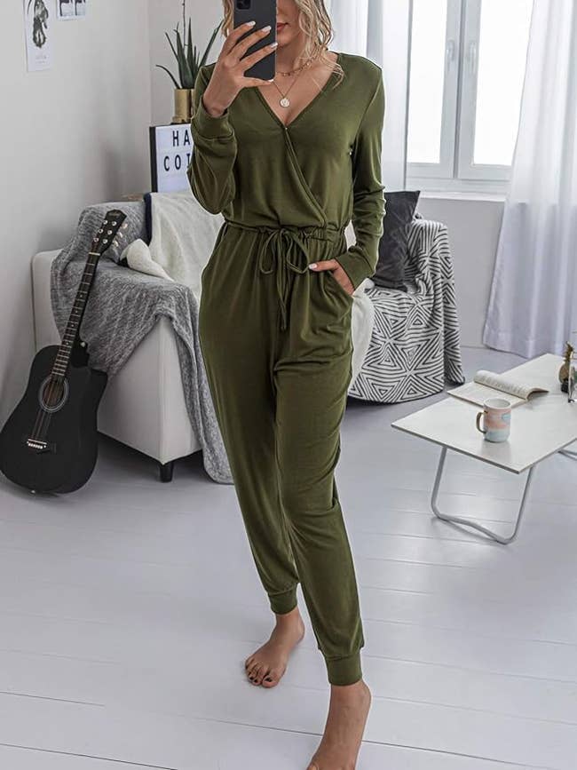 Model wearing green long sleeve jumpsuit