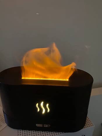 a reviewer's humidifier with red flame looking smoke coming out
