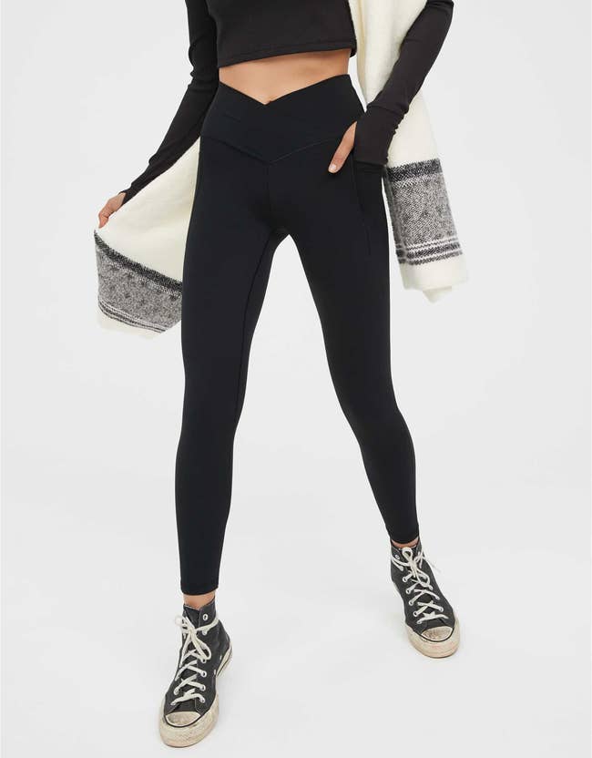 model wearing black leggings with a V-shaped crossover waist band