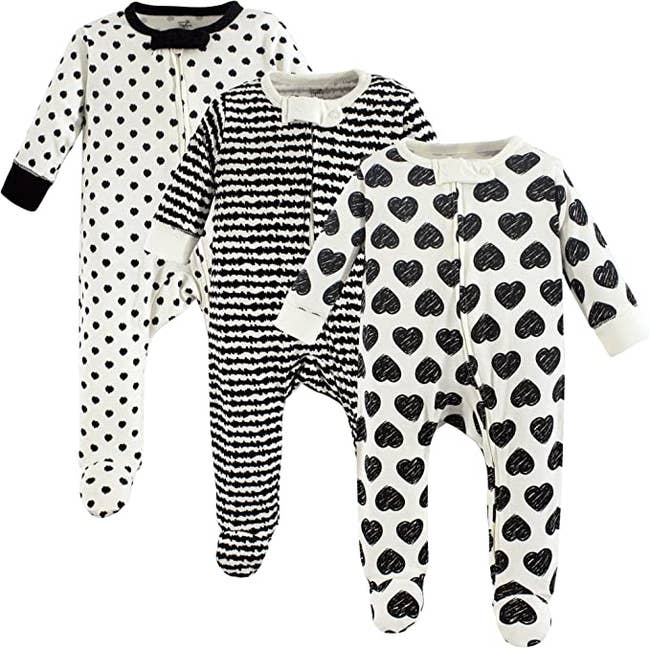 a set of footed pajamas in black and white designs