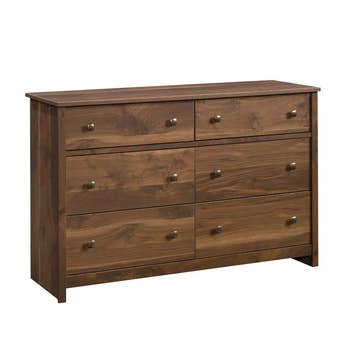 six drawer dark walnut dresser on a white background