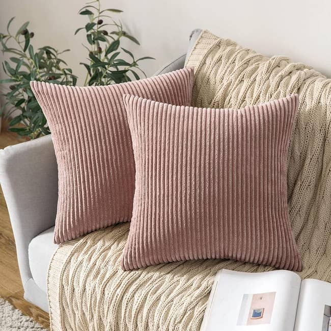 two blush pink corduroy covers on throw pilows