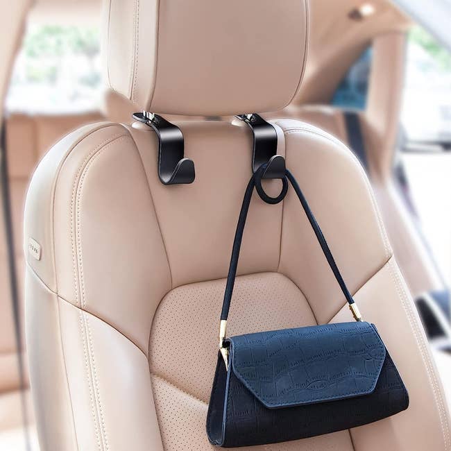 black car hook with purse hanging on it