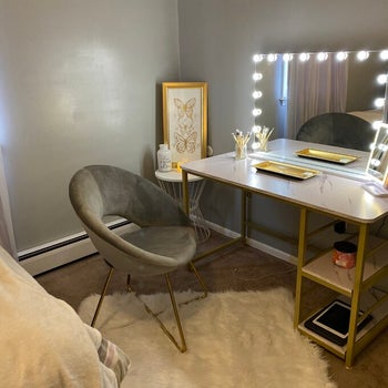 reviewer photo of a gray velvet papasan chair in front of their vanity