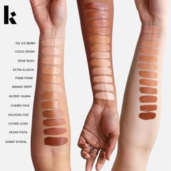 three models with swatches of the concealer on their arm